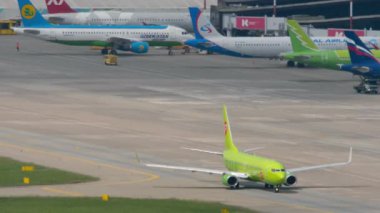 SOCHI, RUSSIA - AUGUST 03, 2022: Boeing 737 of S7 Airlines taxiing on the runway Sochi airport. Airbus Uzbekistan Airways in the background