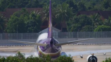 PHUKET, THAILAND - NOVEMBER 27, 2019: Rear view, Boeing 747 of Thai Airways taxiing to the terminal after landing at Phuket Airport. Tourism and travel concept