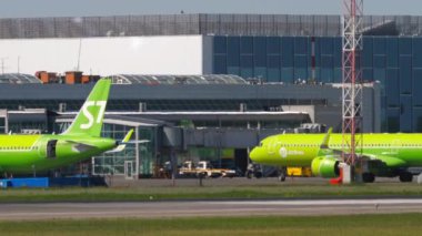NOVOSIBIRSK, RUSSIAN FEDERATION - JUNY 12, 2022: Airbus S7 Airlines taxiing to the terminal at airport Tolmachevo. View of the airport apron
