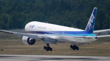 FRANKFURT AM MAIN, GERMANY - JULY 19, 2017: Boeing 777-381ER, JA735A of All Nippon Airways landing and braking at Frankfurt airport. Wide body airliner arrival, side view