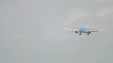 AMSTERDAM, THE NETHERLANDS - JULY 27, 2017: Jet passenger airplane approaching, descending. Boeing 737 of KLM landing at Schiphol Airport, Amsterdam. Civil aircraft arrival
