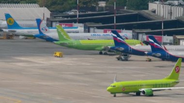 SOCHI, RUSSIA - AUGUST 03, 2022: Boeing 737 of S7 Airlines taxiing on the runway before departure. Row of planes on apron at Sochi airport