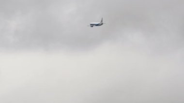 NOVOSIBIRSK, RUSSIAN FEDERATION - SEPTEMBER 28, 2021: Boeing 737 of Atran flies in cloudy rainy sky at Tolmachevo International Airport OVB. Atran Russian cargo airline