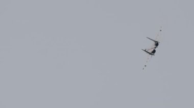 View from below, a military combat aircraft is flying, performing aerobatics. Air show, demonstration flights