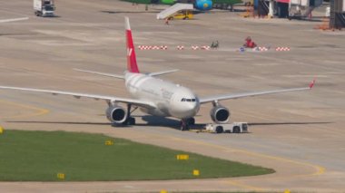 SOCHI, RUSSIA - JULY 29, 2022: Airbus A330 of Nordwind on taxiway at Sochi airport. Yamal airline plane in the background. Tourism and air travel concept