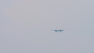 Front view of passenger jet plane approaching before landing over the sea in Sochi airport. Tourism and travel concept