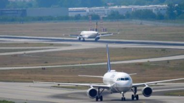 FRANKFURT AM MAIN, GERMANY - JULY 19, 2017: Commercial plane of Lufthansa taxiing at Frankfurt airport. Airfield and haze on a hot day. Lufthansa German flag carrier. Tourism and travel concept