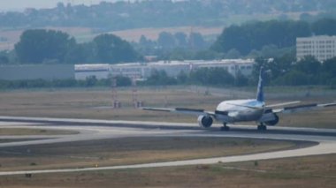 FRANKFURT AM MAIN, GERMANY - JULY 19, 2017: Boeing 777 of All Nippon Airways braking after landing at Frankfurt airport. Widebody airplane arriving, rear view