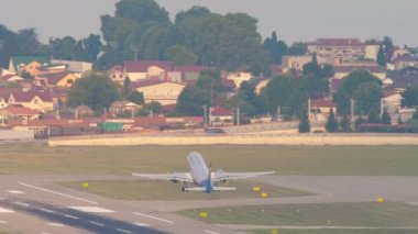 SOCHI, RUSSIA - AUGUST 03, 2022: Airplane of Aeroflot takeoff and climbing at Sochi airport, long shot. Tourism and travel concept