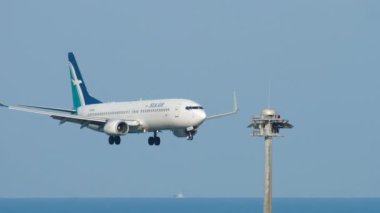 PHUKET, THAILAND - NOVEMBER 30, 2018: Side view footage of Boeing 737, 9V-MGA of SilkAir landing at Phuket airport. SilkAir is a Singaporean airline. Tourism and travel concept