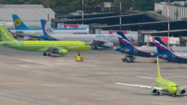 SOCHI, RUSSIA - AUGUST 03, 2022: Boeing 737 of S7 Airlines taxiing on the runway before departure. Airfield, traffic. Row of planes on apron at Sochi airport