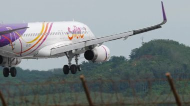 PHUKET, THAILAND - NOVEMBER 27, 2017: Airbus A320, HS-TXT of Thai Smile Airways landing at Phuket airport, side view. Tourism and travel concept