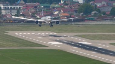 SOCHI, RUSSIA - AUGUST 03, 2022: Widebody aircraft of Aeroflot landing at Sochi airport, front view. Airliner flies over city. Tourism and travel concept