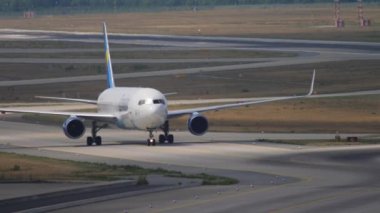 FRANKFURT AM MAIN, GERMANY - JULY 19, 2017: Front view of commercial plane Boeing 767 Condor taxiing after landing at Frankfurt Airport. Tourism and travel concept