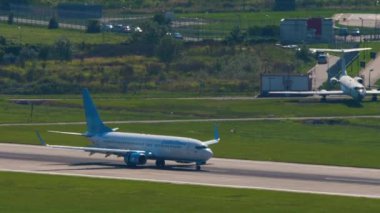 SOCHI, RUSSIA - JULY 28, 2022: Boeing 737 of Pobeda arrival, braking after landing at Sochi airport, side view