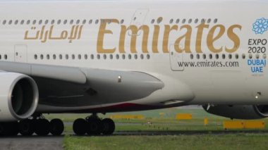 DUSSELDORF, GERMANY - JULY 23, 2017: Passenger airplane Airbus A380 of Emirates taxiing at Dusseldorf airport. Widebody aircraft arrival, side view. Tourism and travel concept