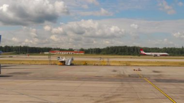 MOSCOW, RUSSIAN FEDERATION - JULY 24, 2021: Apron bus driving along the airfield, delivery of passengers from the terminal building to the gangway of the receiving aircraft
