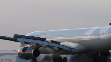 KAZAN, RUSSIA - AUGUST 05, 2022: Airbus A330 of Nordwind braking after landing at Kazan Airport. Airplane on the runway at sunset. Tourism and travel concept