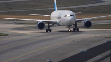 FRANKFURT AM MAIN, GERMANY - JULY 19, 2017: Commercial plane Boeing 767 Condor taxiing after landing at Frankfurt Airport. Airliner on the airfield, taxiway. Tourism and travel concept