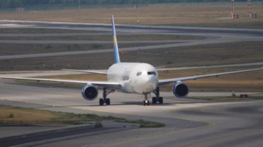 FRANKFURT AM MAIN, GERMANY - JULY 19, 2017: Commercial plane Boeing 767 of Condor taxiing after landing at Frankfurt Airport. Tourism and travel concept