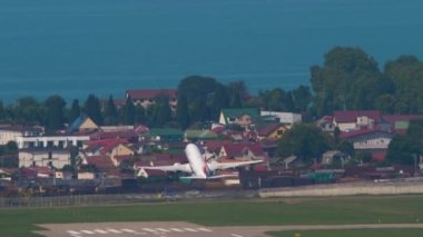 SOCHI, RUSSIA - JULY 31, 2022: Aircraft of Nordwind taking off, fly away at Sochi International Airport. Airliner departure, slow motion. Tourism and travel concept