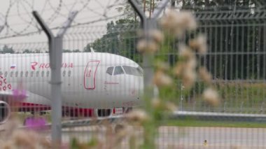 MOSCOW, RUSSIAN FEDERATION - JULY 28, 2021: Passenger plane Sukhoi Superjet of Rossiya taxiing at Sheremetyevo Airport SVO. Tourism and travel concept. Airplane on the taxiway
