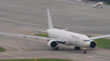 SOCHI, RUSSIA - AUGUST 03, 2022: Boeing 777 of Nordwind Airlines taxiing at Sochi airport, front view. Airliner on the taxiway. Airplane arriving. Tourism and travel concept