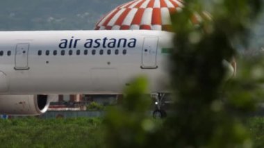 ALMATY, KAZAKHSTAN - MAY 4, 2019: Airbus A321neo, P4-KDC of Air Astana taxiing on the runway at Almaty airport, side view. Mid shot, airplane on the airfield