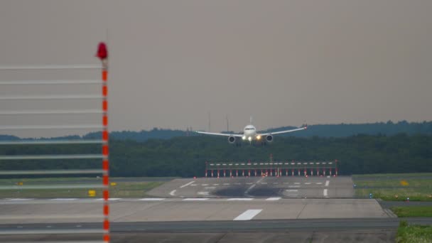 デュッセルドルフ空港に着陸する前に近づいている旅客機 滑走路の端からの眺め — ストック動画