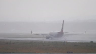 FRANKFURT AM MAIN, GERMANY - JULY 20, 2017: Poor visibility on the airfield, bad weather. Jet plane boeing 737 of AirBerlin landing in heavy rain at Frankfurt Airport