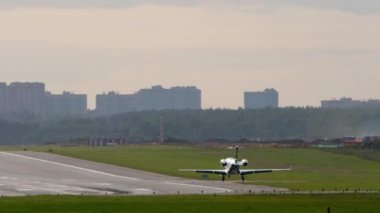 Airplane landing, rear view. Airliner arriving, airfield view. Tourism and travel concept