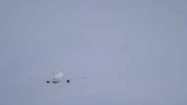 PHUKET, THAILAND - NOVEMBER 28, 2019: Long shot of passenger plane Boeing 757 Sunday Airlines takeoff, climbing at Phuket Airport, Thailand. Aviation, tourism and travel concept