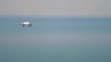 SOCHI, RUSSIA - JULY 27, 2022: Passenger jet airplane of Azimuth landing at Sochi airport. Short haul passenger aircraft arriving. Airplane and sea background. Tourism and travel concept