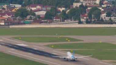 SOCHI, RUSSIA - JULY 29, 2022: Boeing 737 Pobeda Airlines departure at Sochi airport. Airplane take off and climb over the sea, rear view. Tourism and travel concept