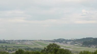 Panoramic view of the airfield and traffic. Time lapse, planes landing and taking off. Airport and sea background