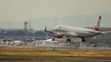 FRANKFURT AM MAIN, GERMANY - JULY 20, 2017: Embraer E195LR, OE-LWA of Austrian Airlines approaching to land at Frankfurt Airport. Jet plane flies. Aircraft arriving. Tourism and travel concept