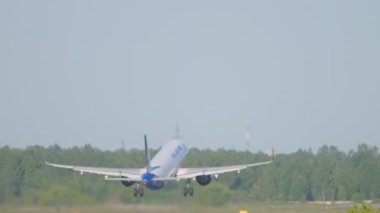 NOVOSIBIRSK, RUSSIAN FEDERATION - JUNE 12, 2022: Airbus A321 of Ural Airlines fly away at Tolmachevo airport. Airliner departure, rear view