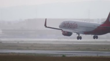 FRANKFURT AM MAIN, GERMANY - JULY 20, 2017: Jet plane boeing 737, D-ABKA of AirBerlin landing in heavy rain at Frankfurt Airport. Poor visibility on the airfield, bad weather.