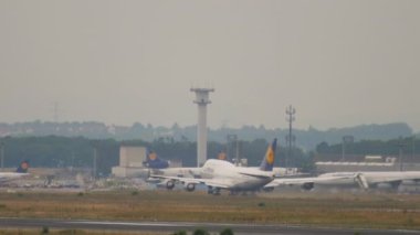 FRANKFURT AM MAIN, GERMANY - JULY 20, 2017: Boeing 747 Lufthansa taking off in a downpour at Frankfurt Airport. Widebody plane departure, fly away