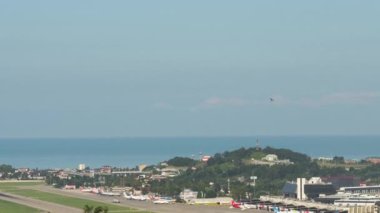 SOCHI, RUSSIA - JULY 29, 2022: Time-lapse footage of the airfield at Sochi airport, sea background