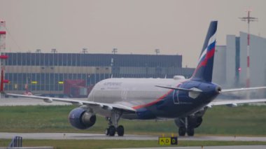 MOSCOW, RUSSIAN FEDERATION - JULY 28, 2021: Passenger airplane of Aeroflot taxiing on the runway, rear view. Tourism and travel concept