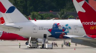 PHUKET, THAILAND - NOVEMBER 28, 2019: Boeing 777, VQ-BZY of Azur Air Azur Bear Livery on the airport apron. Boarding passengers on a flight. Airport staff aircraft maintenance