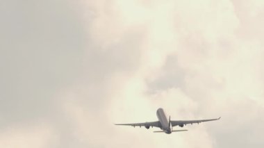 Silhouette passenger airplane flying away in to sky high altitude. Tourism and travel concept