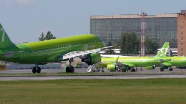 NOVOSIBIRSK, RUSSIAN FEDERATION - JUNE 12, 2022: Plane of S7 Airlines landing, touching and braking at Tolmachevo airport. Traffic on a summer day, airfield. Tourism and travel concept