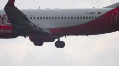 FRANKFURT AM MAIN, GERMANY - JULY 20, 2017: Jet plane boeing 737, D-ABKA of AirBerlin landing in heavy rain at Frankfurt Airport. Poor visibility on the airfield, bad weather.