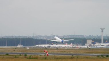 FRANKFURT AM MAIN, GERMANY - JULY 20, 2017: Passenger plane of Condor Airlines taking off and climbing at Frankfurt Airport. Long shot, airliner departure. Tourism and travel concept