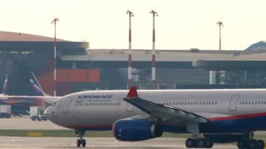 MOSCOW, RUSSIAN FEDERATION - JULY 30, 2021: Footage of passenger plane Airbus A330 Aeroflot taxiing on the background of the airport, terminal. Tourism and travel concept