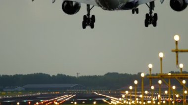 AMSTERDAM, THE NETHERLANDS - JULY 28, 2017: Cinematic footage of a Delta Airlines aircraft landing and braking, rear view. Landing lights illuminate the runway. Tourism and travel concept