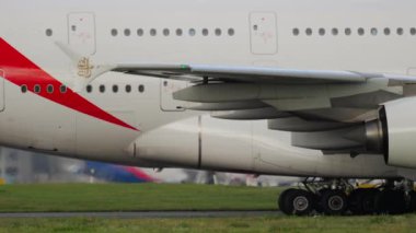 DUSSELDORF, GERMANY - JULY 23, 2017: Plane Airbus A380 of Emirates taxiing at Dusseldorf airport. Widebody aircraft arrival, side view. Tourism and travel concept