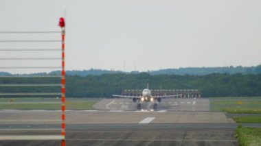 Front view of an airplane flying, landing. Runway, traffic. Airliner arrival. Tourism and travel concept